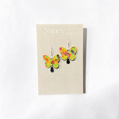 Butterfly earrings on a Nancy Jones branded card against a white background