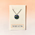 Necklace with a colorful pendant on a &