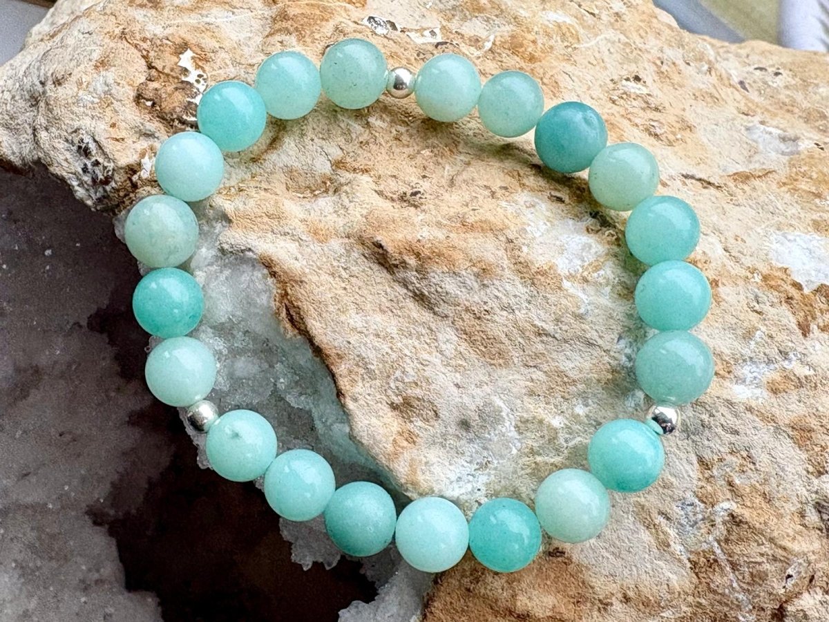 Turquoise beaded bracelet on a rock with crystals