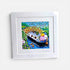 Framed artwork of a boat with a person on a white background