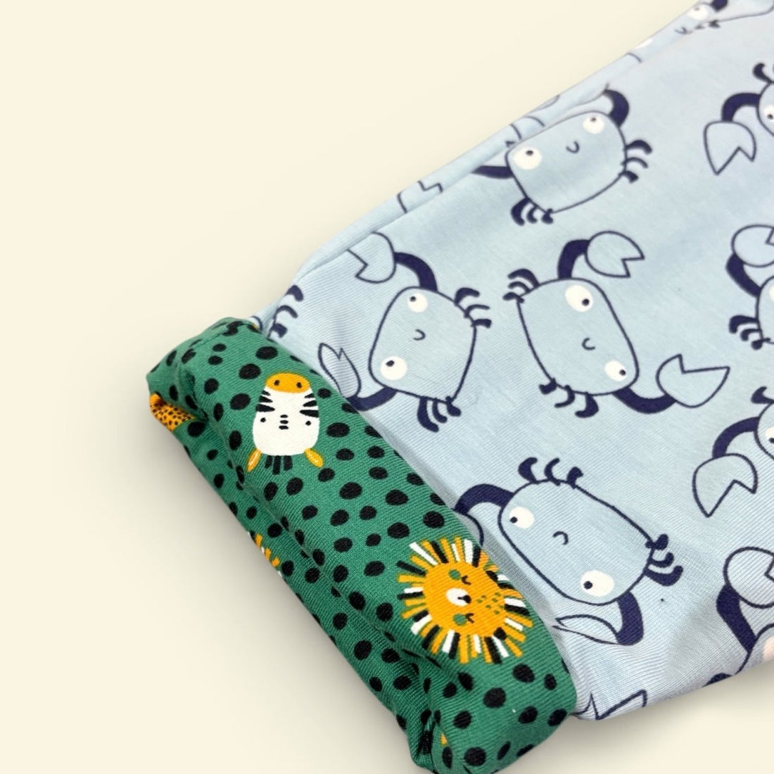 Two fabric swatches with animal patterns on a beige background