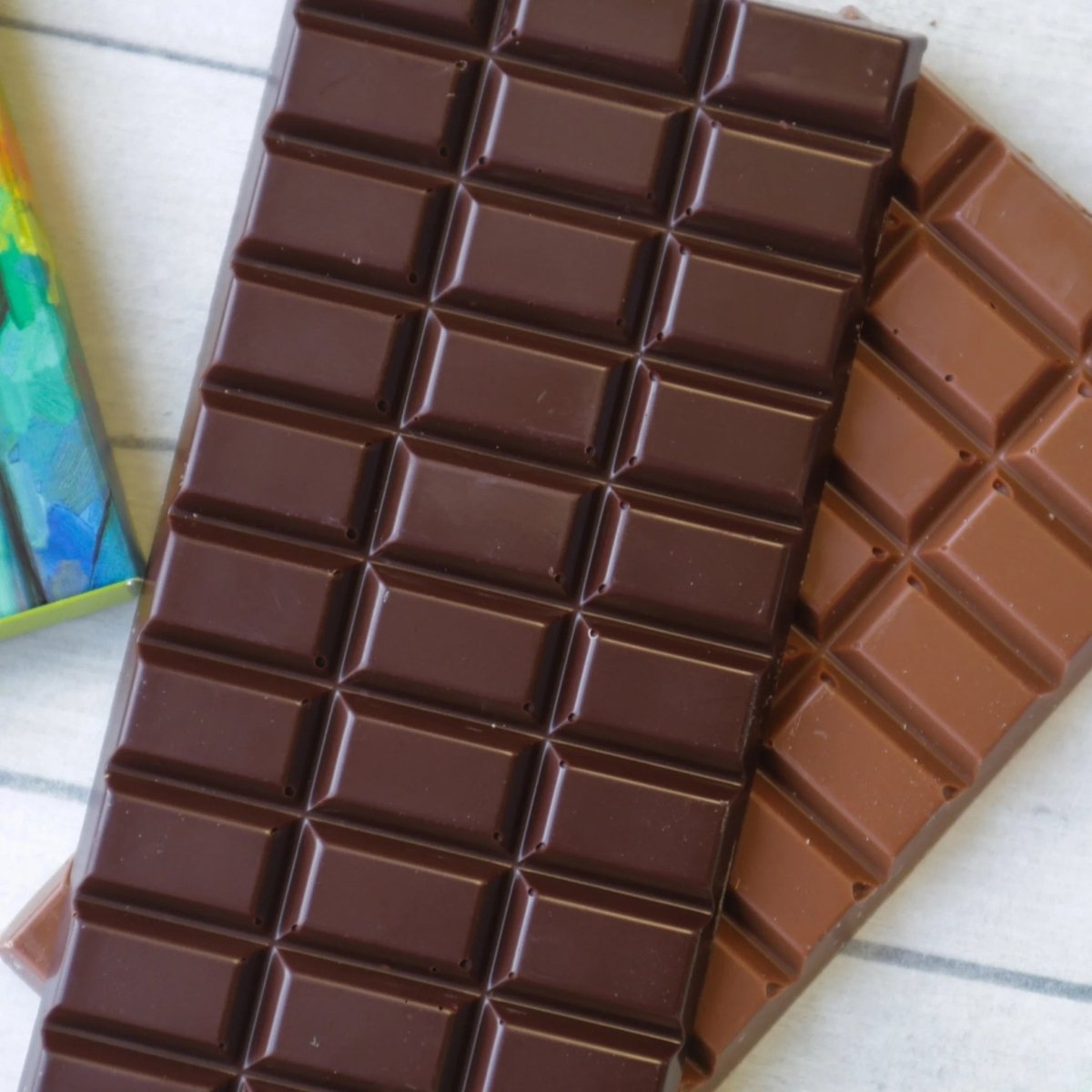 Chocolate bars with a grid pattern on a light surface