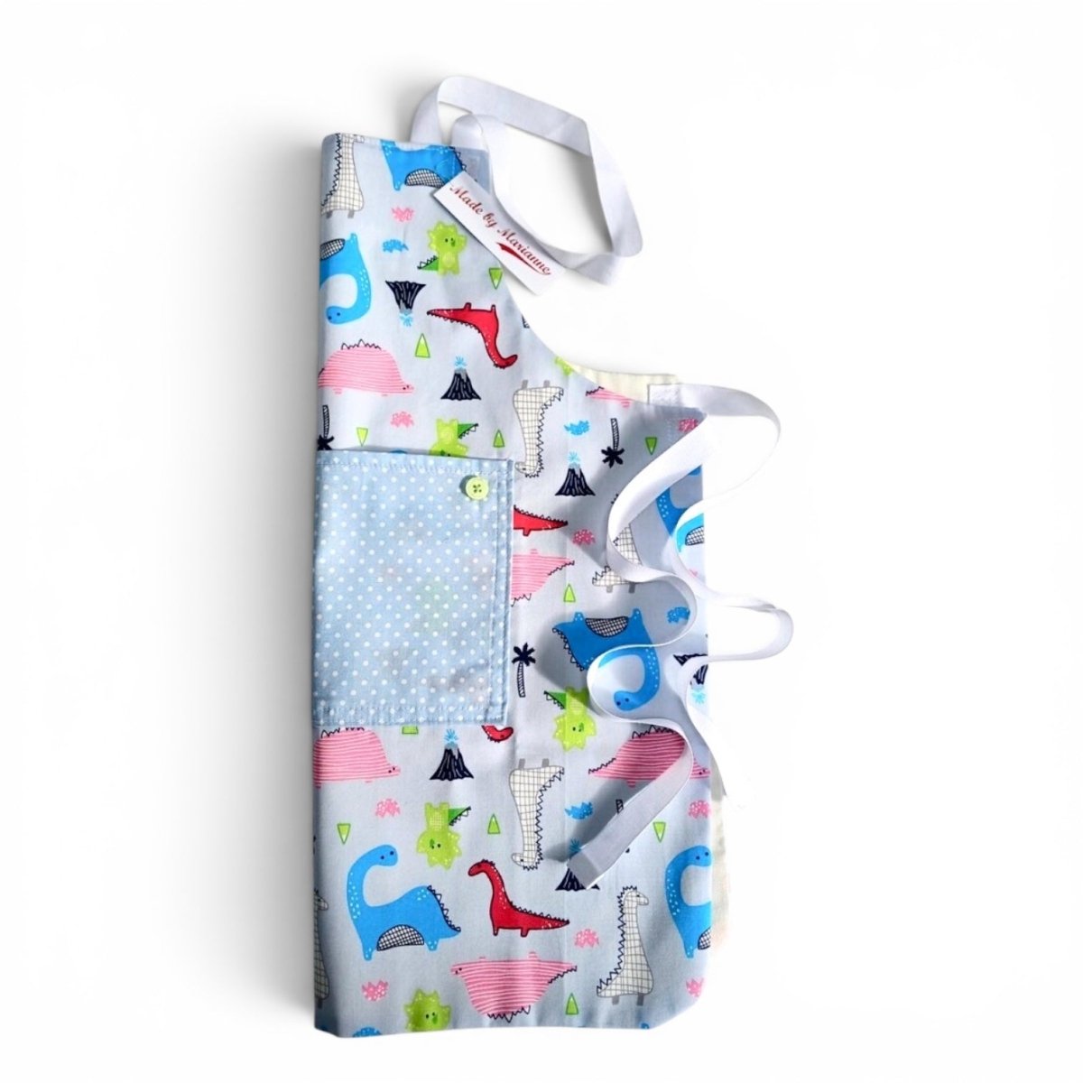 A light blue apron with a colorful dinosaur print and a solid light blue pocket, shown on a plain white background.