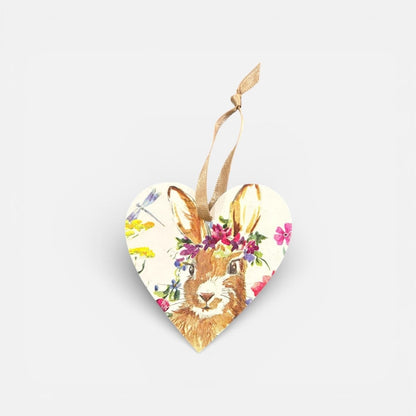 Heart-shaped ornament with a rabbit design and floral elements on a white background