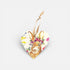 Heart-shaped ornament with a rabbit design and floral elements on a white background