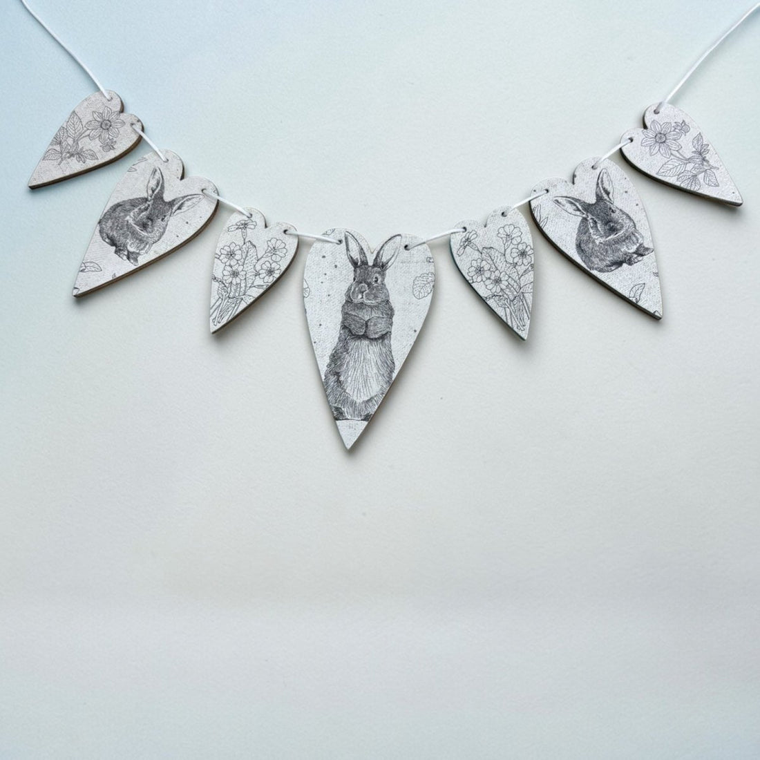 Decorative banner with rabbit illustrations on a light blue background