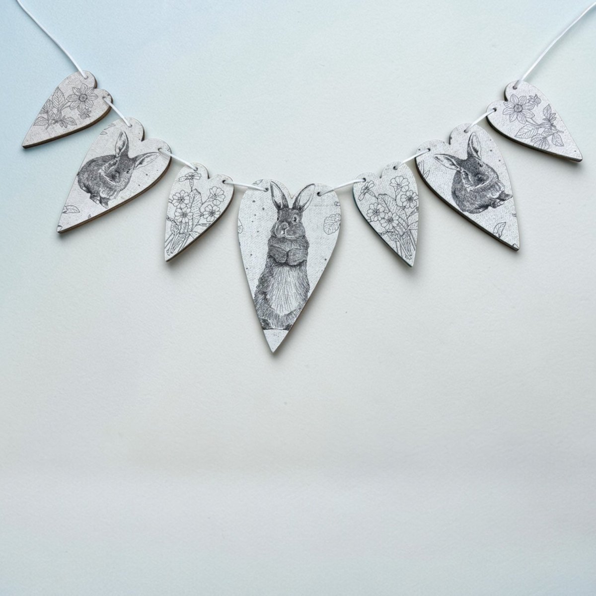 Decorative banner with rabbit illustrations on a light blue background