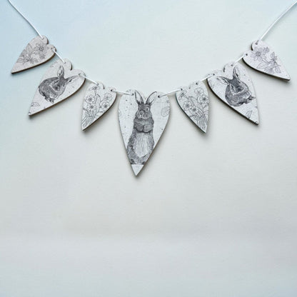 Decorative banner with rabbit illustrations on a light blue background