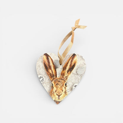 Heart-shaped hanging ornament with a hare design on a light gray background