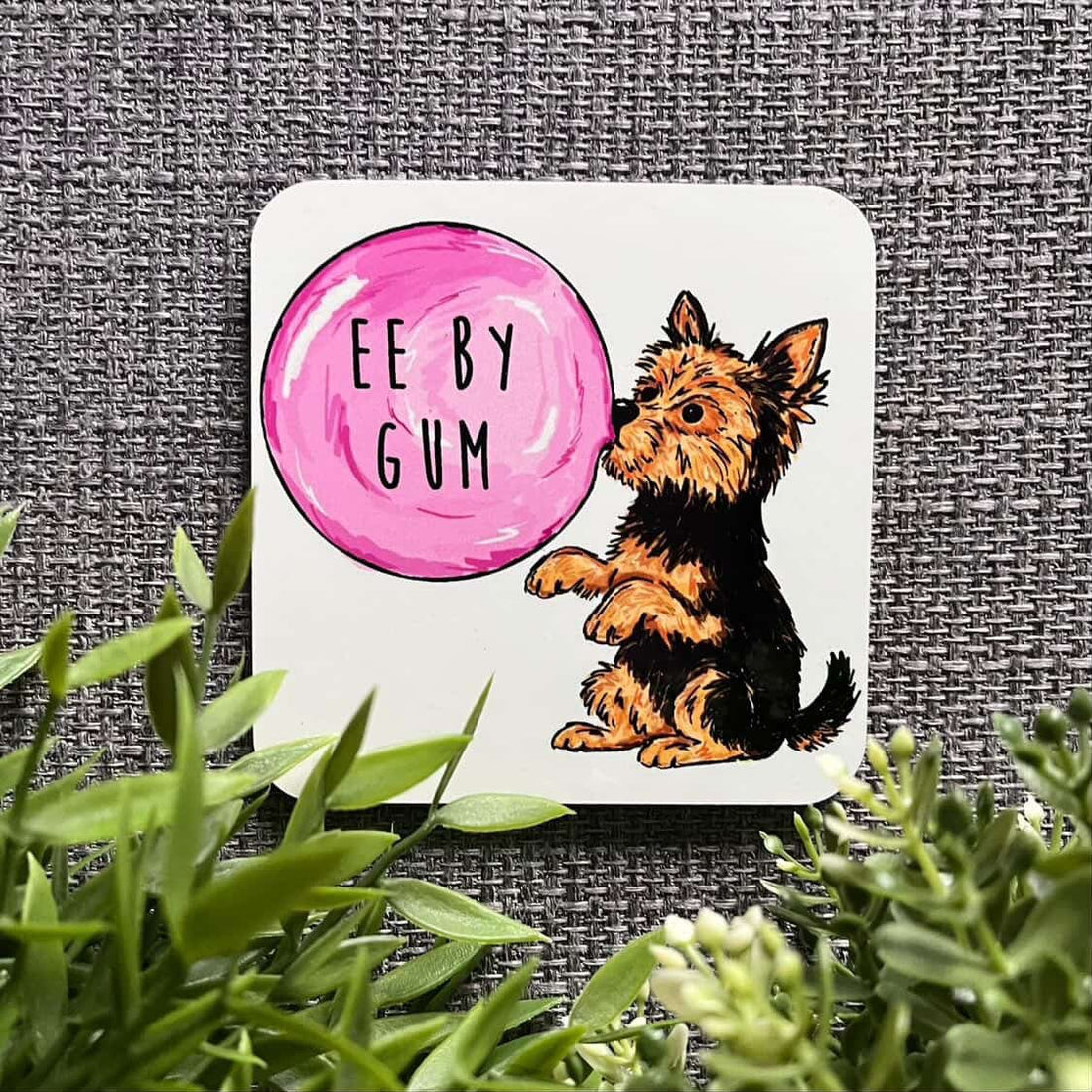 Coaster with a dog and pink bubble gum bubble labeled &