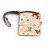 A small crossbody bag with a beige floral print, featuring white blossoms, red flowers, and a brown strap, shown on a white background with a product tag attached.