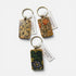 Three rectangular keychains with floral artwork from William Morris&