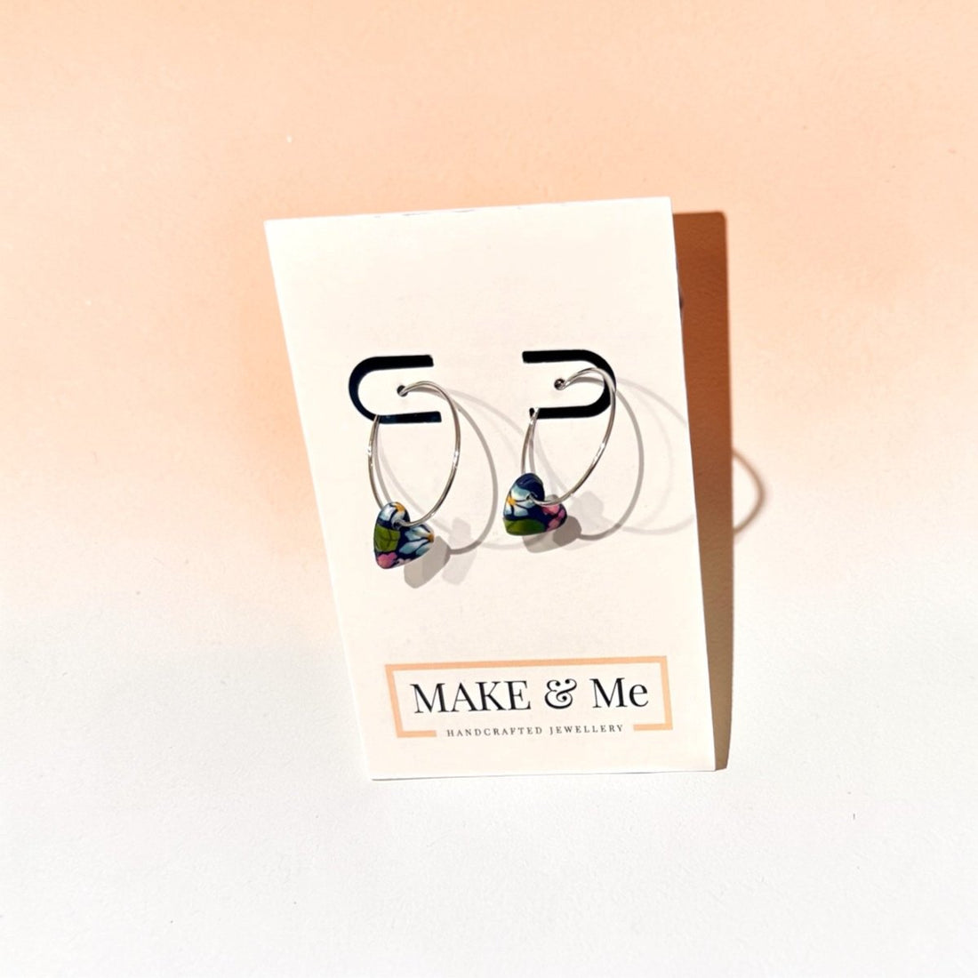 Make &amp; Me jewelry card with heart-shaped earrings on a gradient background