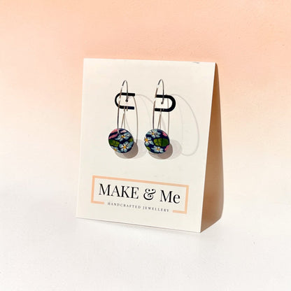 Make &amp; Me handcrafted jewellery earrings on a display card with a pink gradient background
