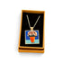 A gold-tone chain necklace with a square pendant featuring a colorful painting of pink flowers in an orange pot, displayed inside an open tan gift box with a black velvet insert on a white background.