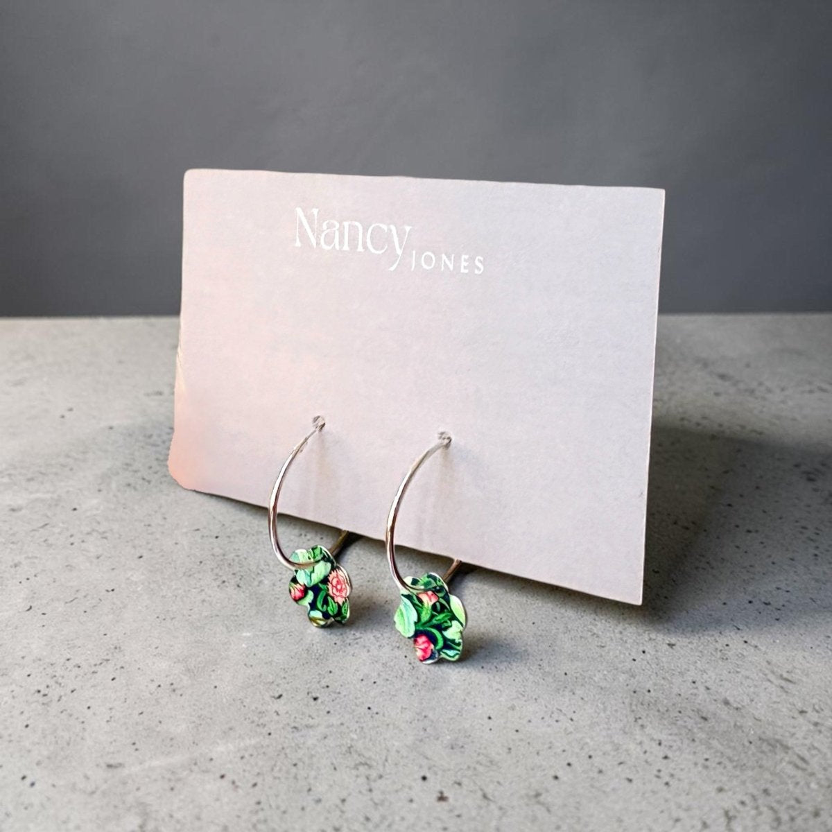 Floral hoop earrings on a card with &