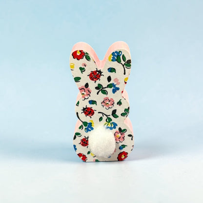 Decorative bunny with floral and ladybug pattern on a light blue background