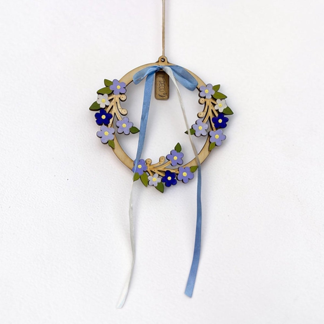 Decorative wreath with flowers and ribbons on a white background