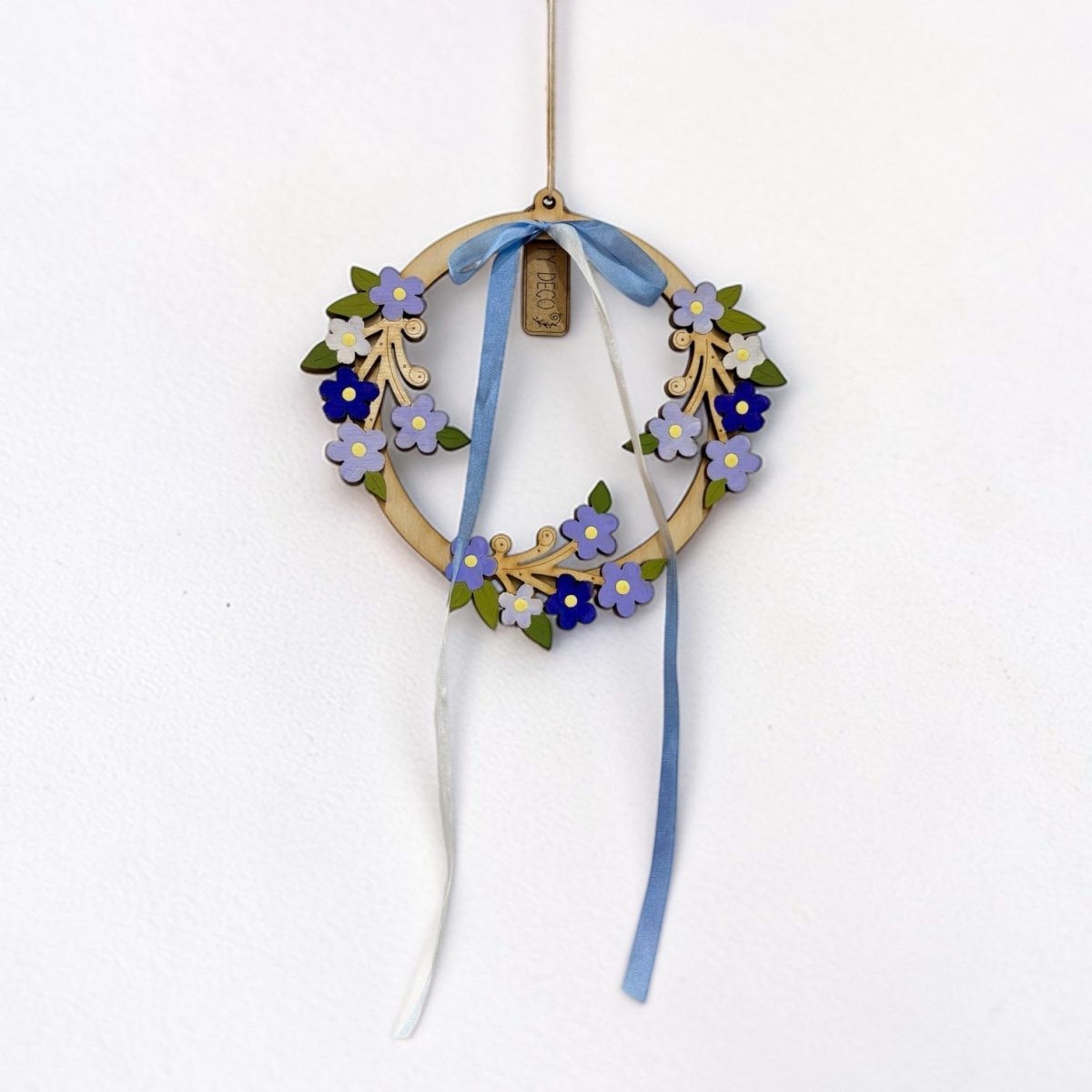 Decorative wreath with flowers and ribbons on a white background