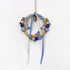 Decorative wreath with flowers and ribbons on a white background