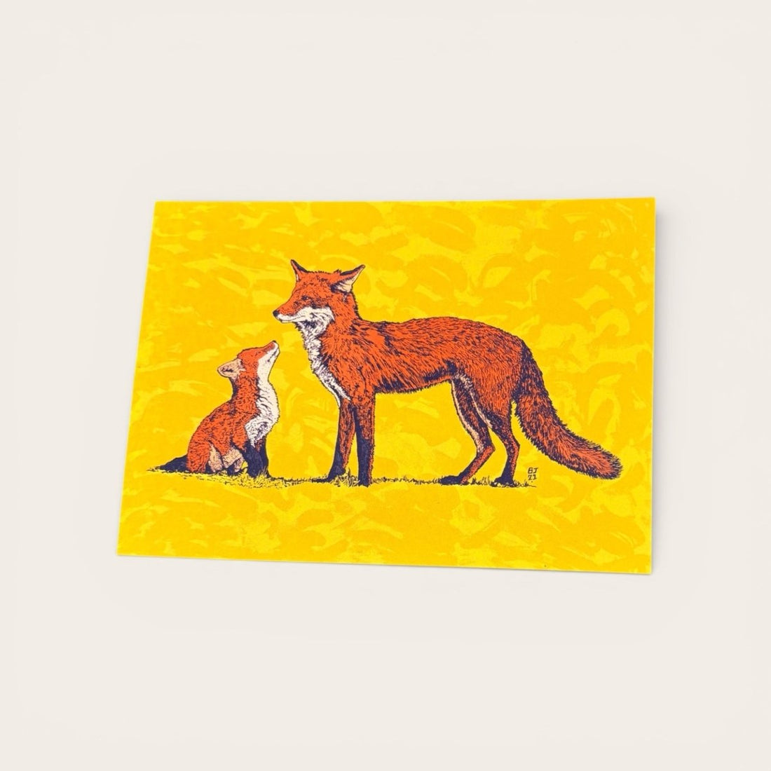 Two foxes on a yellow background with a subtle pattern