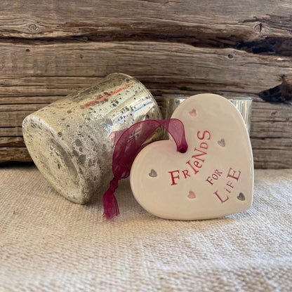 Heart-shaped ceramic piece with &