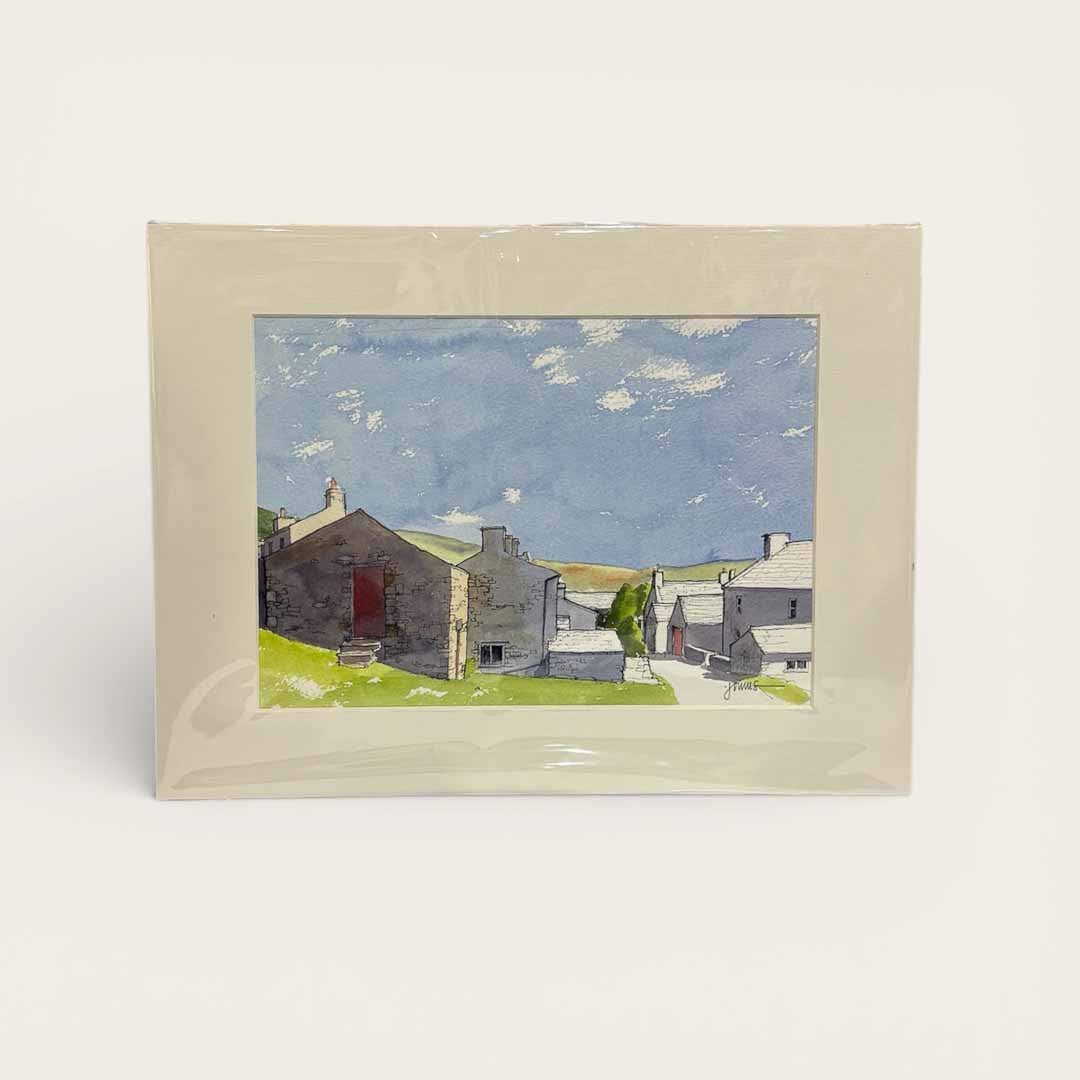 Framed artwork of a village scene with houses and a blue sky.