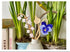 Decorative elements with hand-painted birchwood stems and a blue flower in a white vase.