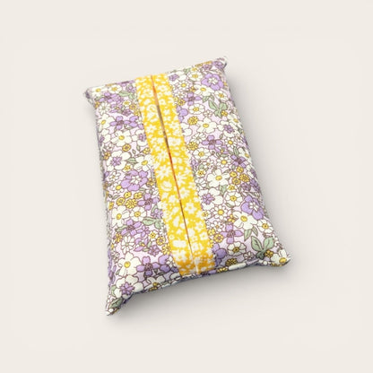 Floral-patterned pillow with a yellow stripe on a light gray background