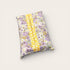 Floral-patterned pillow with a yellow stripe on a light gray background