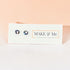 Make & Me earrings on a branded card with a pink background