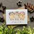 Easter card with chicks wearing hats on a textured surface with decorative elements.