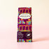 Vegan rice milk chocolate bar with colorful packaging on a light pink background