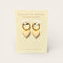 Heart-shaped earrings on a Collette Haigh branded card with a beige background