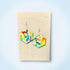 Colorful hexagonal earrings on a Nancy Jones card against a light blue background