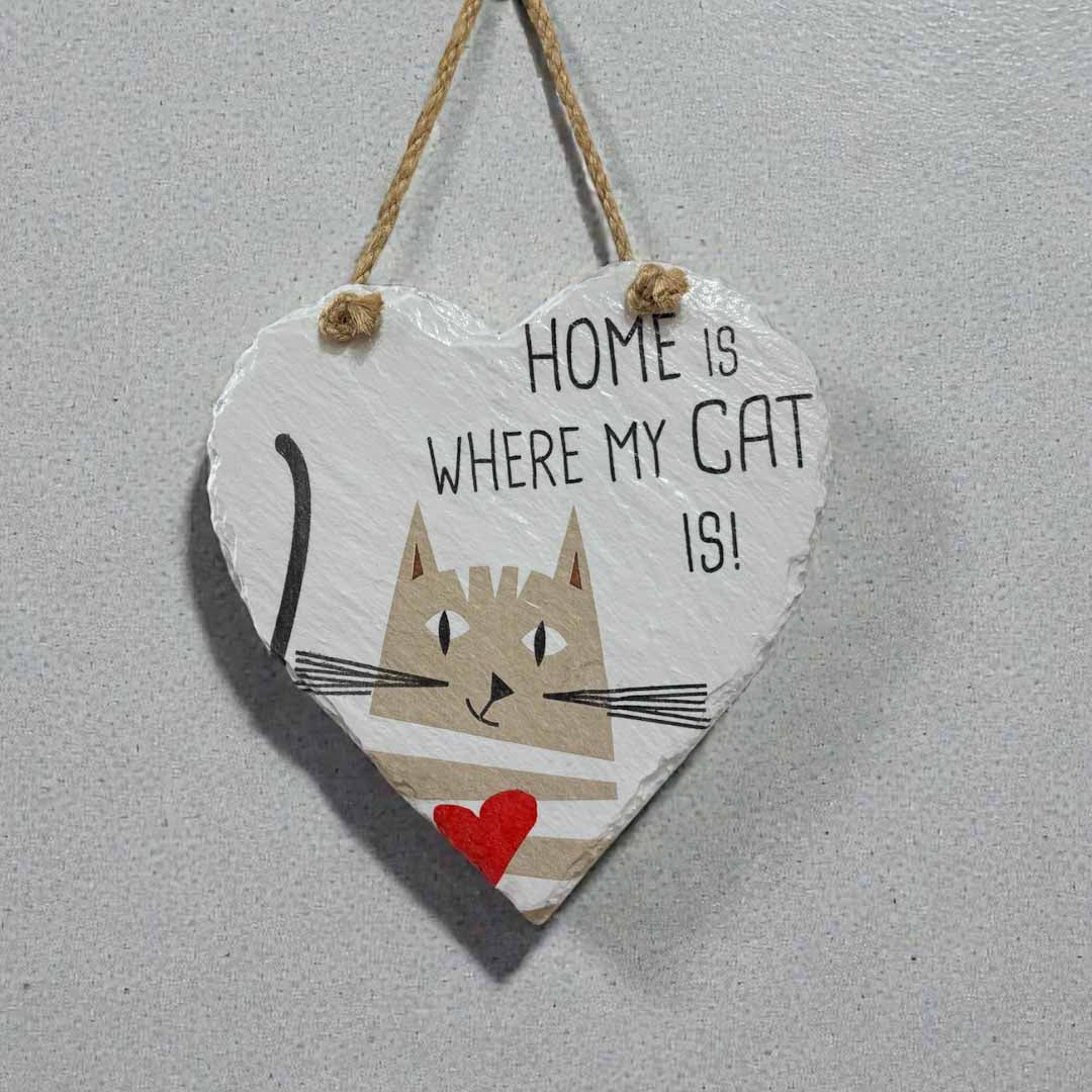 Heart-shaped sign with a cat illustration and text &