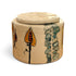 A round ceramic lidded container with a beige base and hand-painted botanical motifs in orange, green, and black, shown on a plain white background.