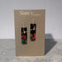 A pair of Nancy Jones dangle earrings displayed on a taupe jewelry card. The earrings feature rectangular black pendants decorated with red and orange flowers and white birds, suspended from silver hooks.