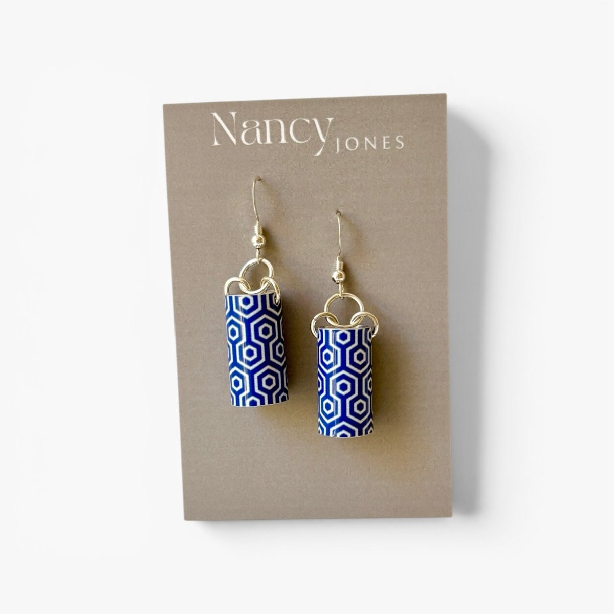 Blue and white patterned earrings on a Nancy Jones card.