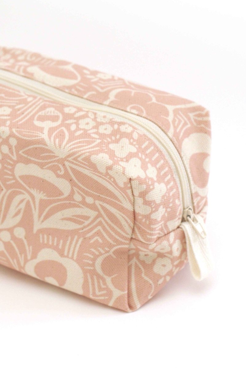 Pink toiletry bag with floral pattern on a white background