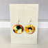 Nancy Jones earrings on a display card with artistic design