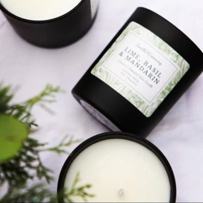 Two candles with labels on a white surface, one of which is open to reveal a green interior.