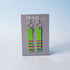 Pair of earrings with colorful patterns on a gray card with &