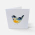 A folded white greeting card standing upright on a light gray background, featuring a watercolor-style bird illustration in blue, yellow, and black.