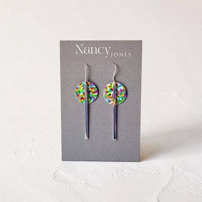 Colorful dot earrings on a Nancy Jones card against a white background
