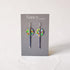 Colorful dot earrings on a Nancy Jones card against a white background