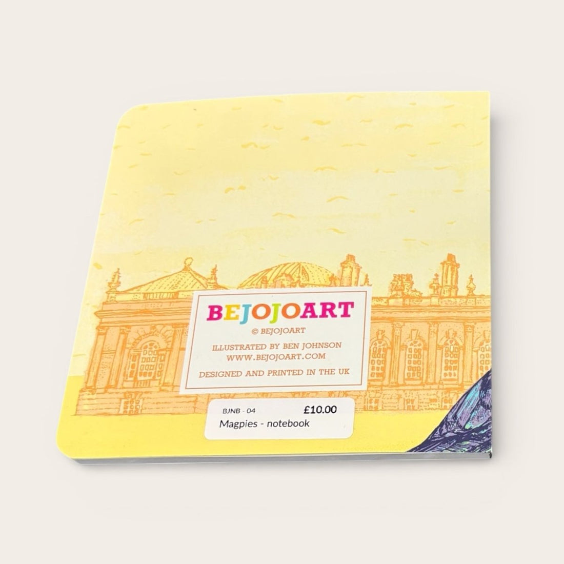Notebook with yellow cover featuring architectural illustration and &