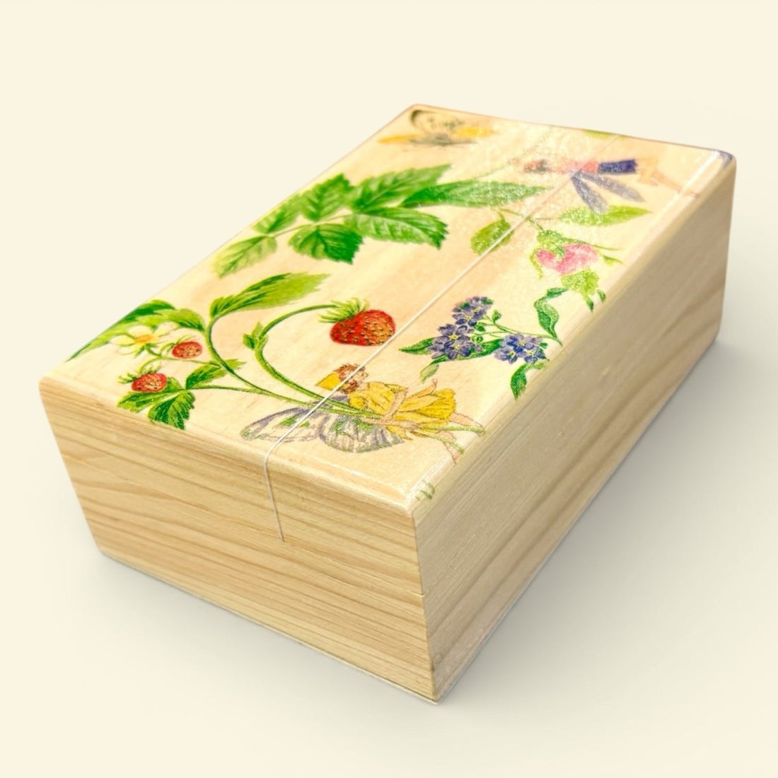 Wooden box with floral and butterfly design on a light background