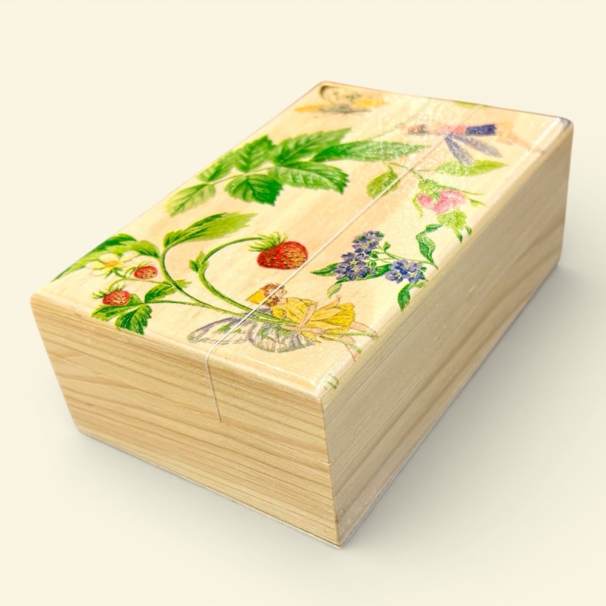 Wooden box with floral and butterfly design on a light background