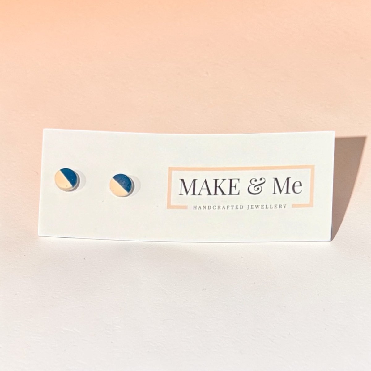Make &amp; Me earrings on a branded card with a pink gradient background